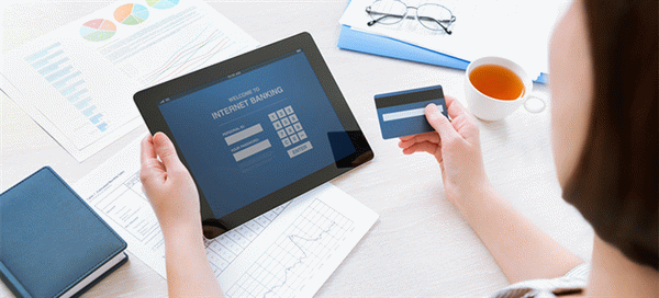 Businesswoman using a credit card for online internet banking